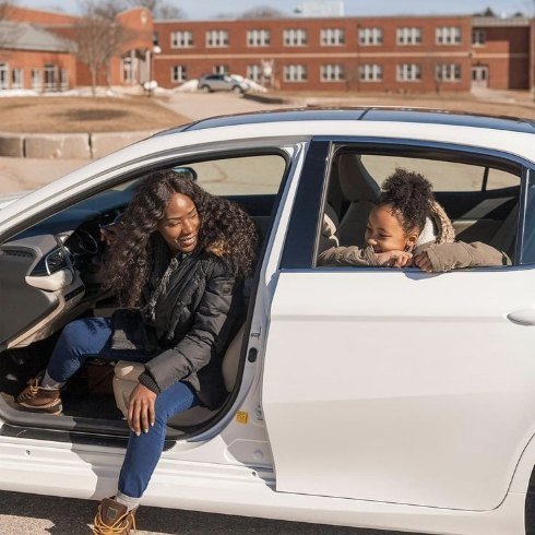 Altrip driver smiling with a student in the car