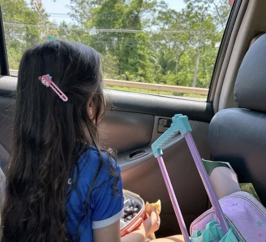 Student riding to school with her backpack and lunch